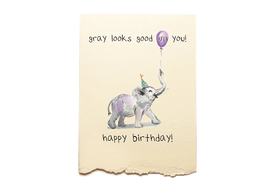 Birthday card with an elephant holding a balloon and text on a beige background