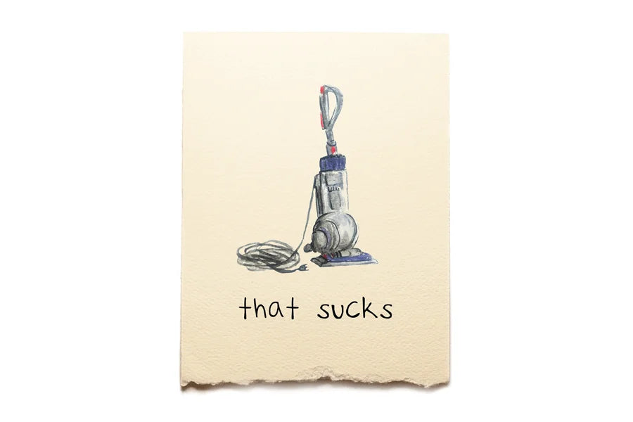 Cartoon vacuum cleaner on a piece of paper with 'that sucks' text