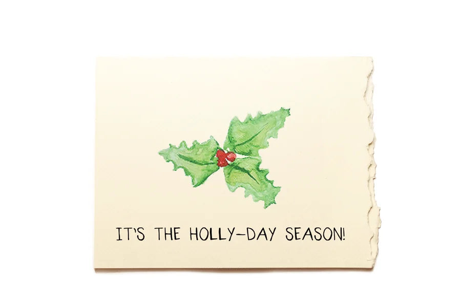 Christmas card with holly design and text 'It's the Holly-day Season!' on a white background