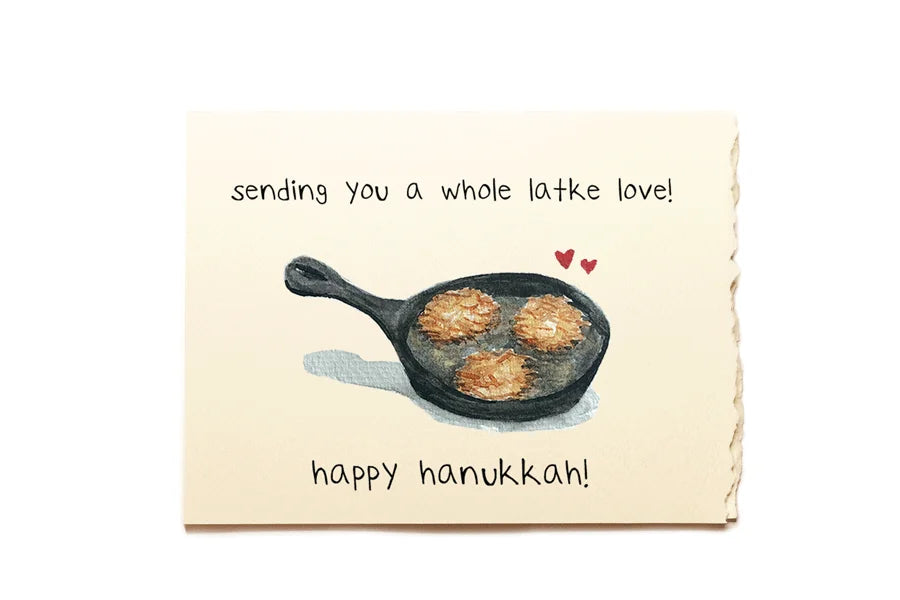 Hanukkah card with a frying pan of latkes and text 'sending you a whole latke love! happy hanukkah!' on a beige background.