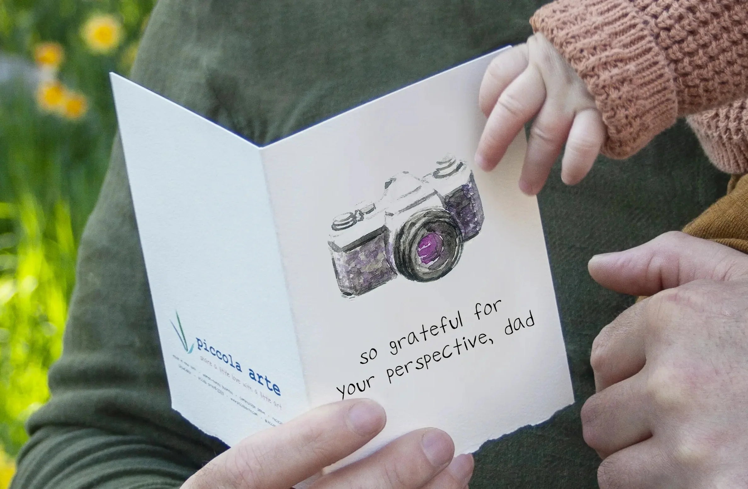 Father and baby holding greeting card that says "so grateful for your perspective, dad"