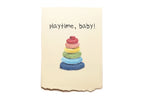 Colorful stack of rings on a beige card with 'playtime, baby!' text