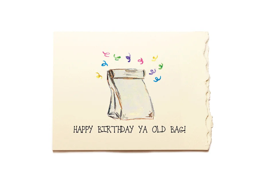 Birthday card with a drawing of a bag and colorful text on a beige background
