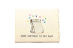 Birthday card with a drawing of a bag and colorful text on a beige background