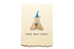 Greeting card with a teddy bear wearing a party hat and bow tie, and text 'happy bear-thday!' on a beige background.