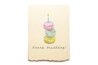 Happy Birthday card with colorful macaron stack and candle on a beige background
