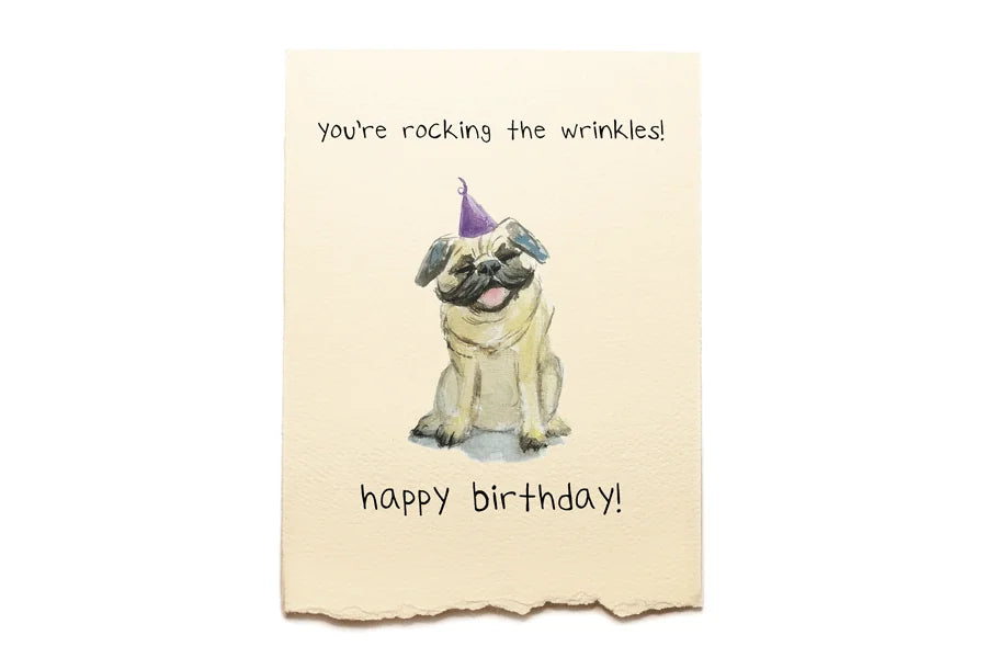 Birthday card with a pug wearing a party hat and text on a beige background
