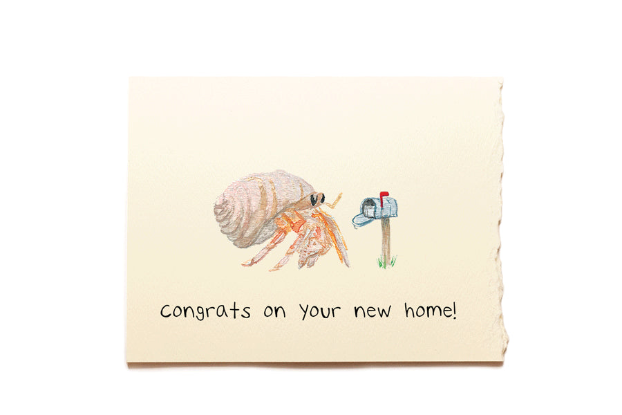 Card with a hermit crab and mailbox illustration and 'Congrats on your new home!' text.