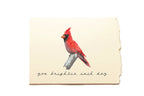 Card with a red cardinal illustration and text on a beige background