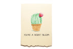 Card with a cactus illustration and text 'You're a desert bloom!' on a beige background