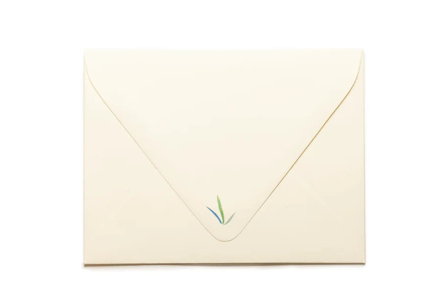 Beige envelope with a green stamp on a white background