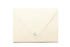 Beige envelope with a green stamp on a white background