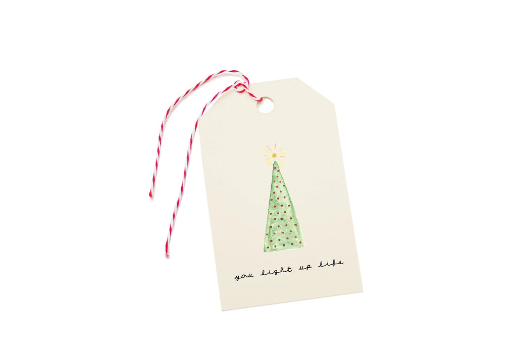 Gift tag with a Christmas tree design and text on a white background.