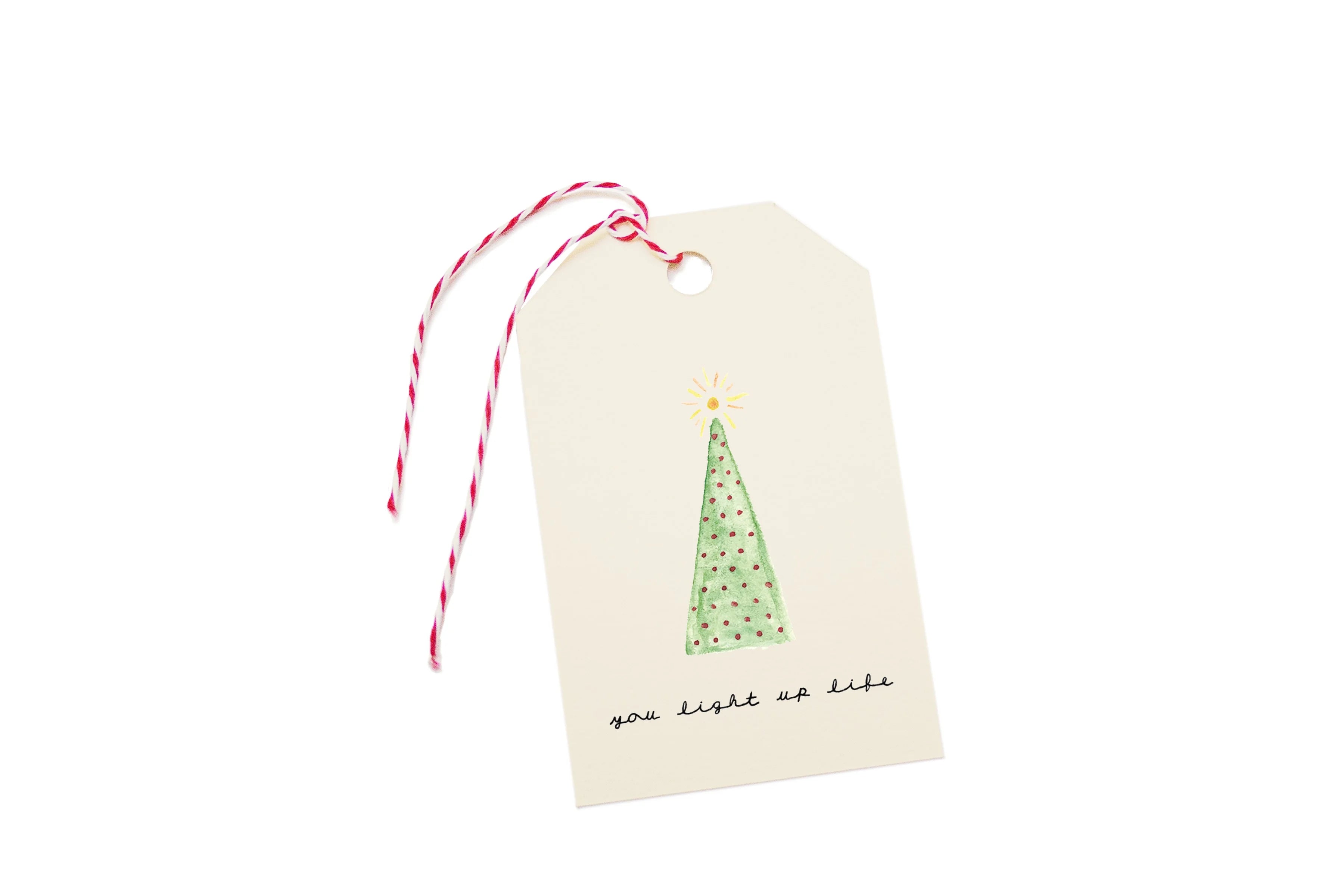 Gift tag with a Christmas tree design and text on a white background.