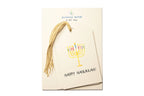 Pack of gift tags with Menorah design and 'Happy Hanukkah!' text on a white background