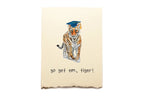 Graduation-themed greeting card with a tiger wearing a cap and 'go get em, tiger!' text on a beige background.
