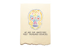 Card with a colorful skull design and text on a beige background