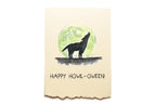 Card with a wolf howling at a green moon and 'Happy Howl-oween!' text on a beige background