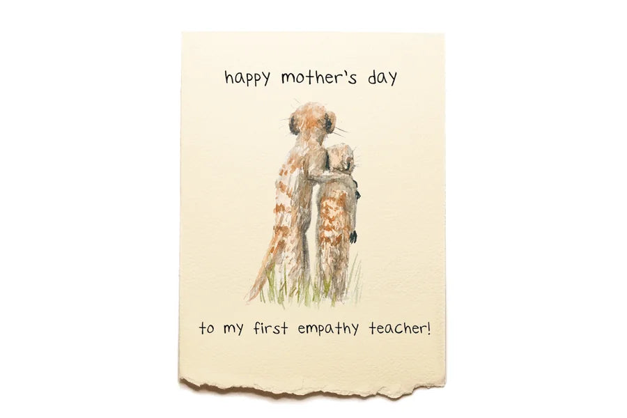 Mother's Day card with illustration of a woman holding a child, text 'happy mother's day to my first empathy teacher' on a beige background.