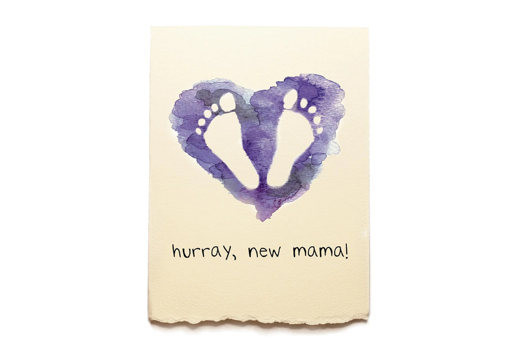 Card with purple heart and footprints on a beige background, featuring the text 'hurray, new mama!'.