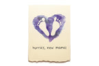 Card with purple heart and footprints on a beige background, featuring the text 'hurray, new mama!'.