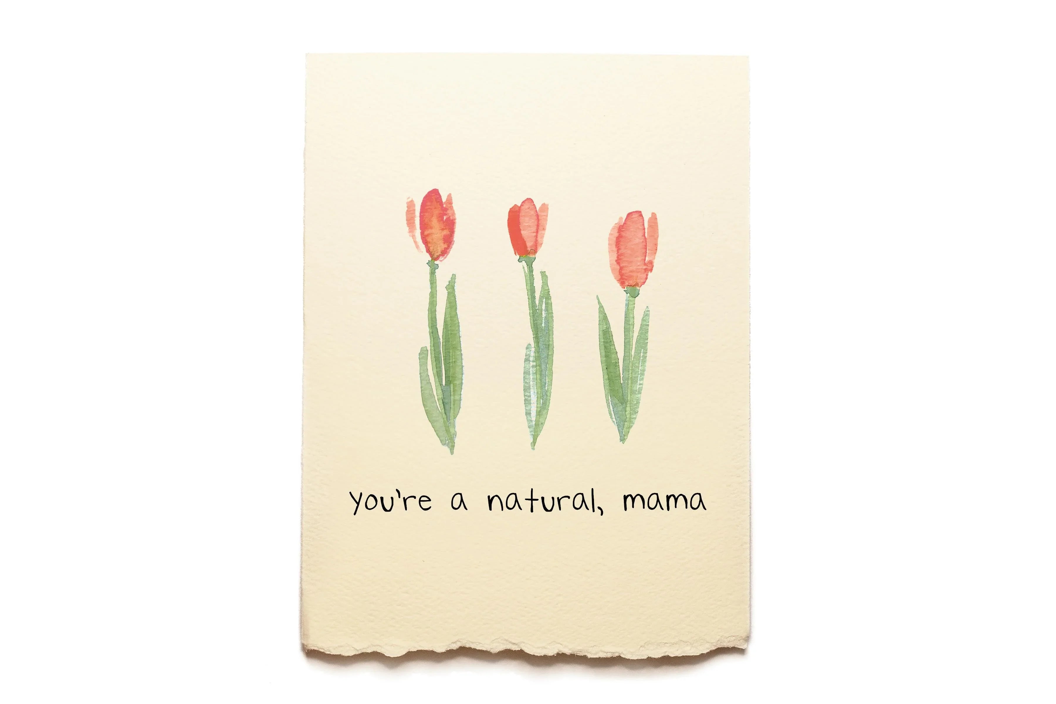 Beige towel with red tulips and text 'you're a natural, mama' on a white background