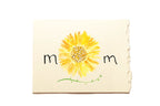 Notebook with a yellow sunflower illustration and 'mom' text on a white background