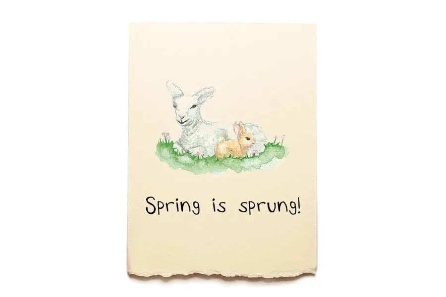 Hand towel with a spring-themed design featuring a lamb and rabbit, text 'Spring is sprung!', on a beige background.