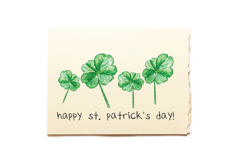 St. Patrick's Day card with four green shamrocks on a beige background