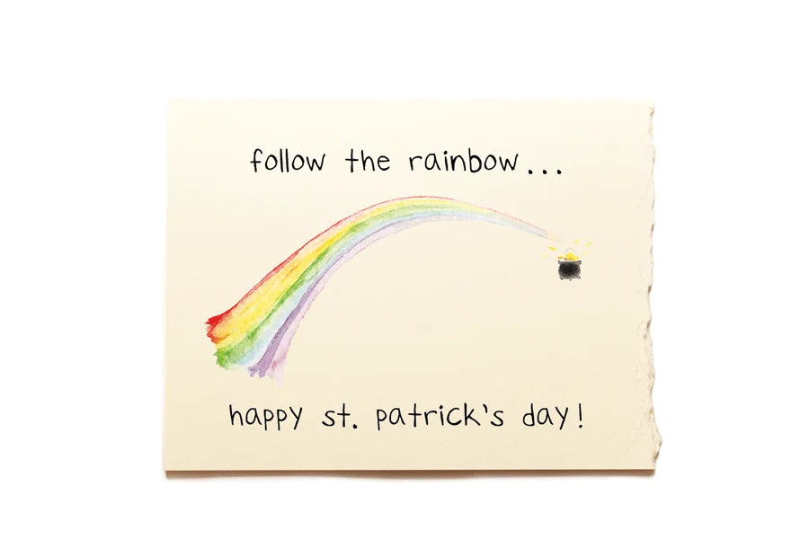 Note with rainbow and text 'follow the rainbow... happy st. patrick's day!' on a beige background