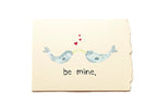 Card with two whales holding hands and hearts, with 'be mine' text on a beige background