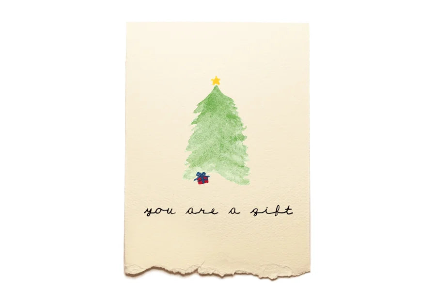 Card with a watercolor Christmas tree and text 'you are a gift' on a beige background