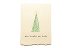 Card with a green Christmas tree and text on a beige background