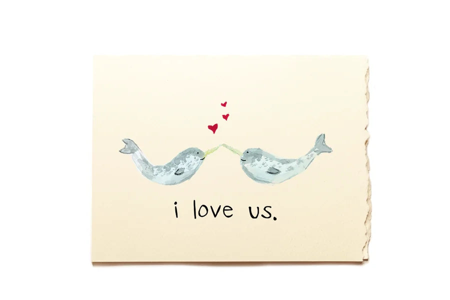 Card with two whales holding hands and 'i love us' text on a beige background