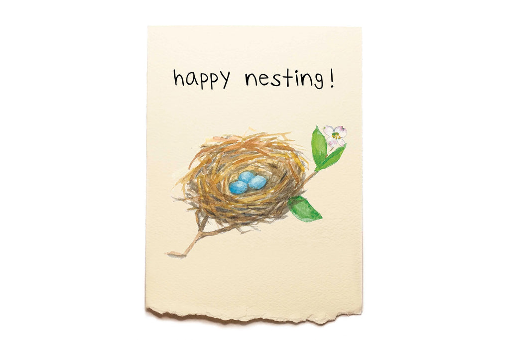 Card with a nest and eggs illustration and 'happy nesting!' text on a beige background