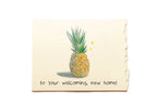Card with a pineapple illustration and text 'to your welcoming, new home!' on a beige background