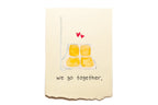 Card with two yellow squares and hearts above, text 'we go together' on a beige background