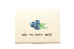 Note card with blueberries and text 'miss you berry much!' on a beige background