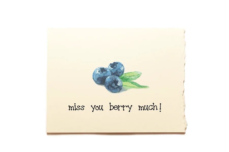 Note card with blueberries and text 'miss you berry much!' on a beige background