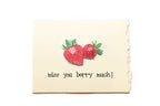 Card with strawberries and text 'miss you berry much!' on a beige background