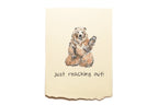 Card with a bear illustration and text 'just reaching out!' on a beige background