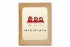 Card with three cartoon characters in red hats and snow boots, with 'FA LA LA LA LA!' text, on a kraft paper background.