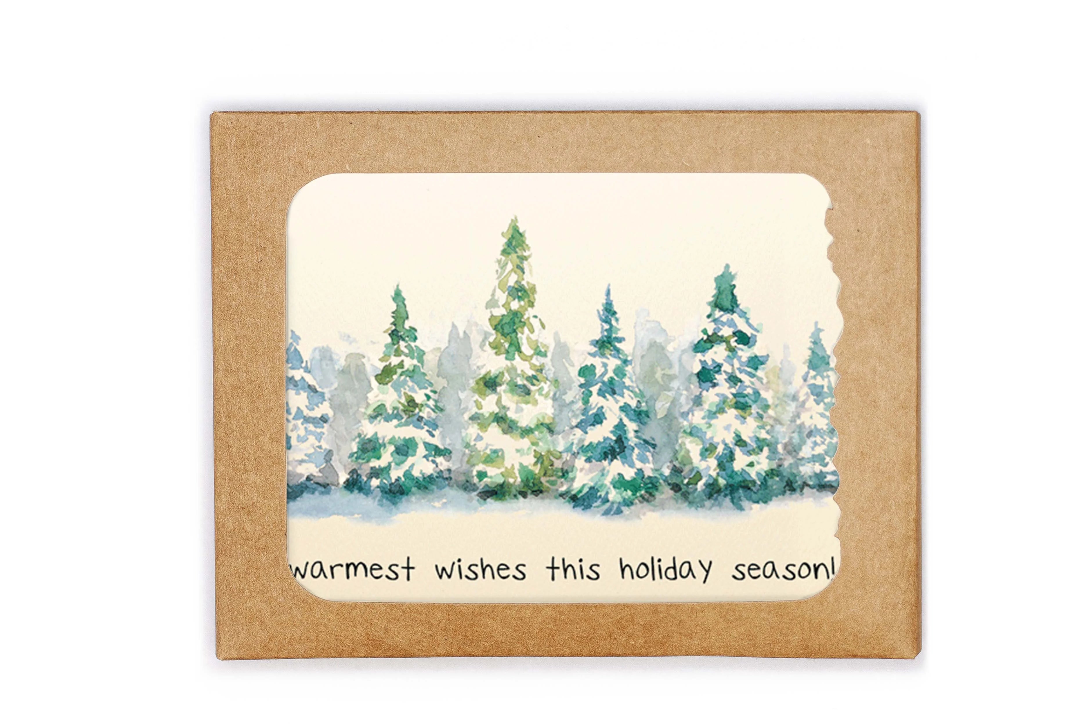 Winter scene with trees and 'warmest wishes this holiday season' text on a kraft paper background