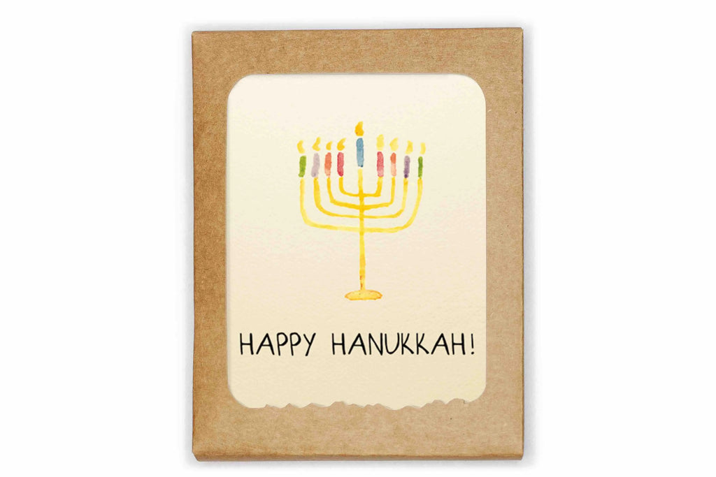 Card with a colorful menorah and 'Happy Hanukkah!' text on a kraft paper background