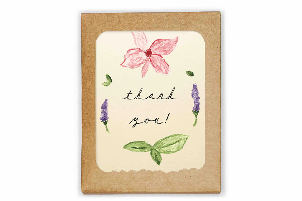 Greeting card with floral design and 'thank you!' text on a kraft paper background