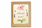 Greeting card with floral design and 'thank you!' text on a kraft paper background