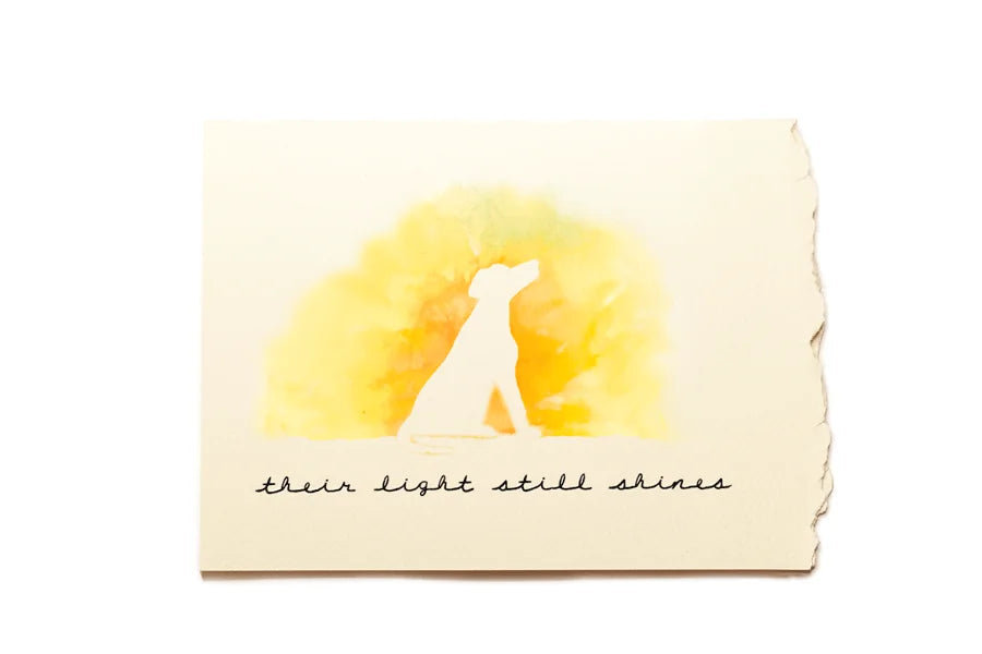 Note card with a silhouette of a dog and watercolor sun, text 'their light still shines' on a white background.