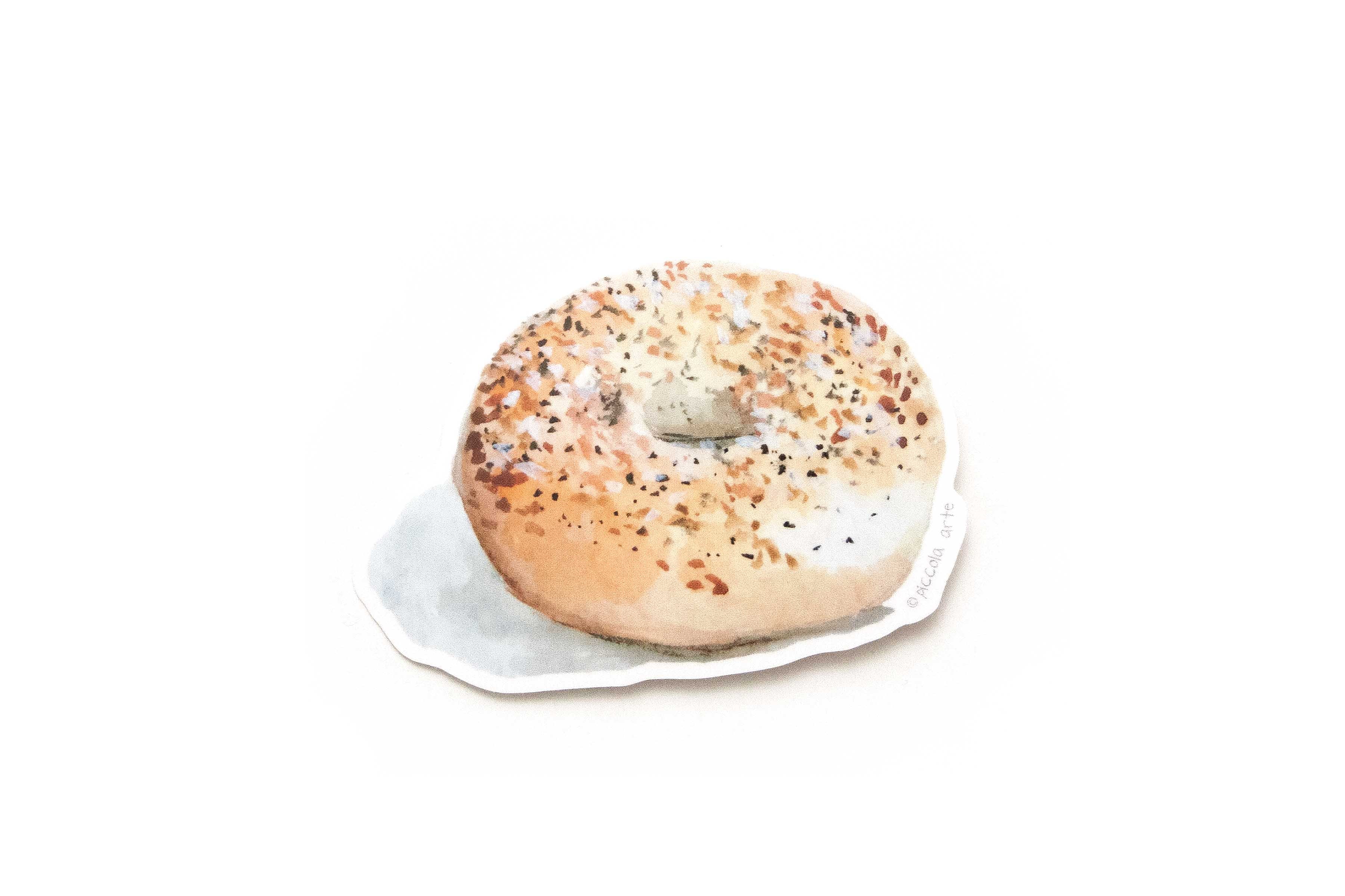 Bagel with sesame seeds and poppy seeds on a white plate with a white background