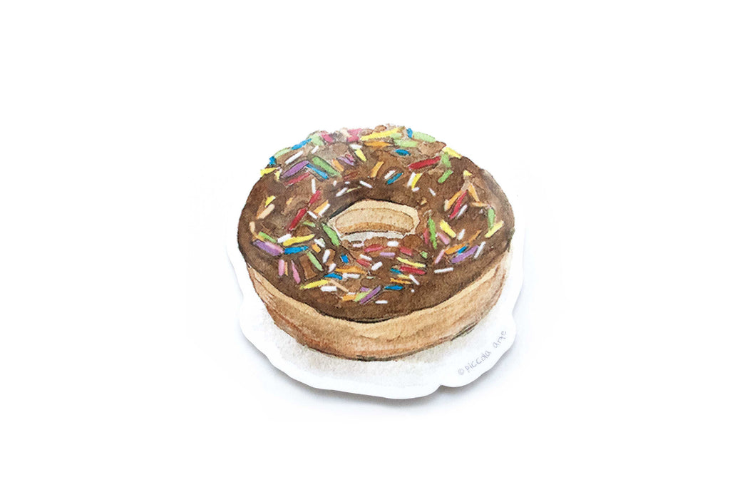 Toy cake with colorful sprinkles on a white background