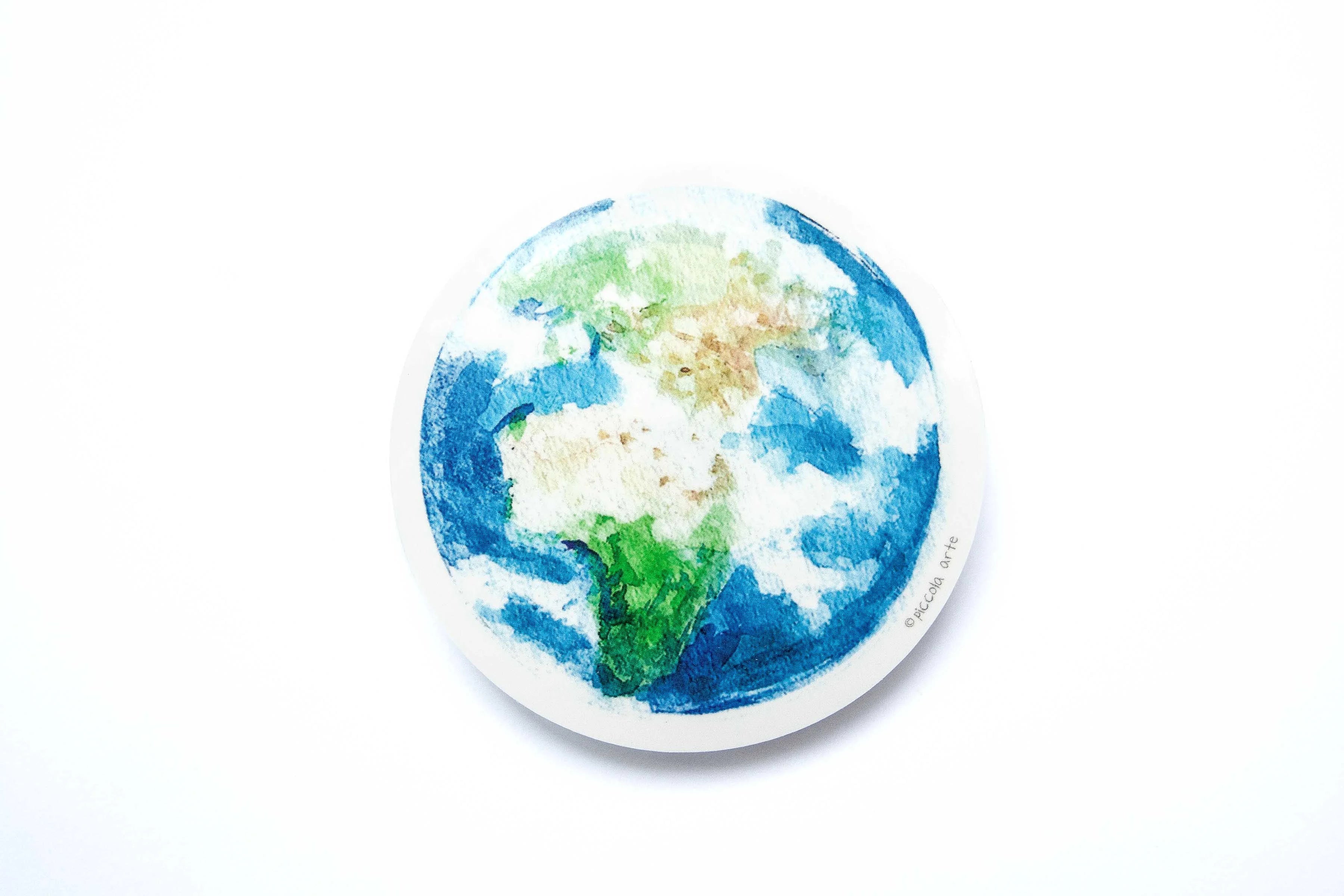 Round sticker with a colorful depiction of the Earth on a white background